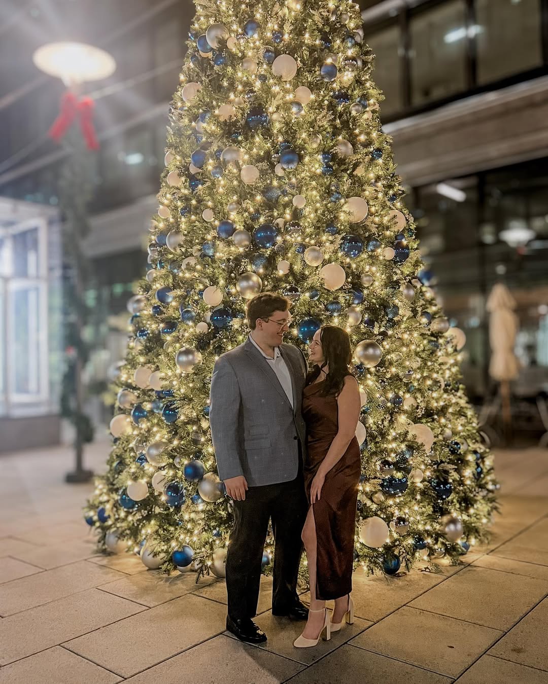 Veronica and Lucas by the Christmas tree
